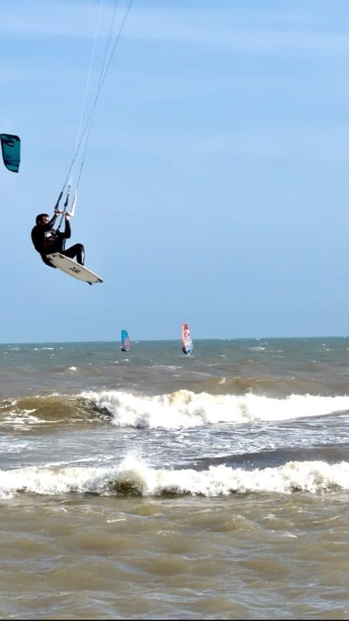 Kitesurfing jump high over the waves