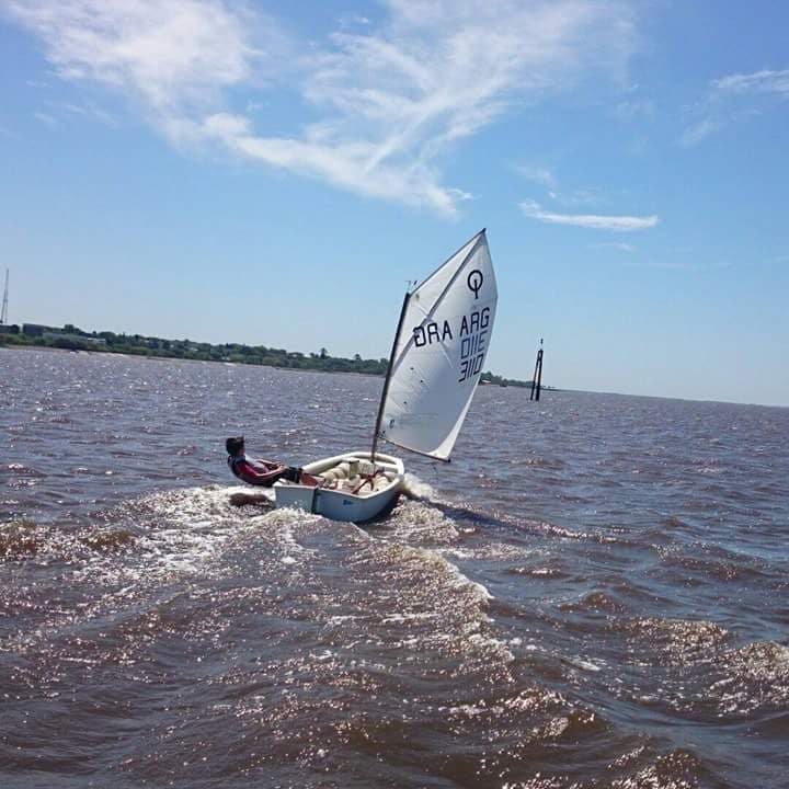 Racing an Optimist dinghy with ARG on the sail